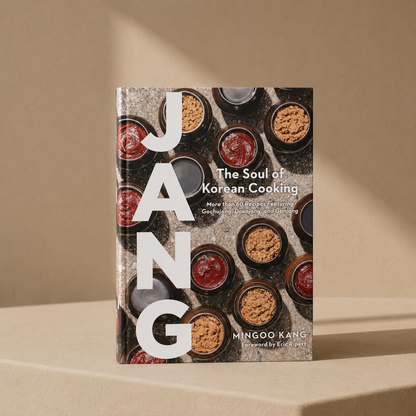 Cookbook titled 'The Soul of Korean Cooking' by Mingoo Kang on a beige background